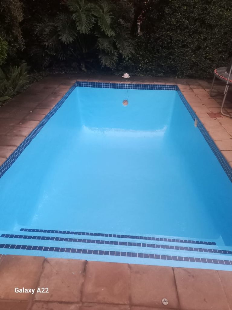 Freshly resurfaced swimming pool with clear blue water